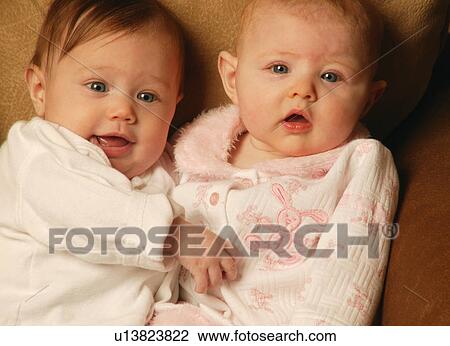 Stock Image - Two babies cuddling. Fotosearch