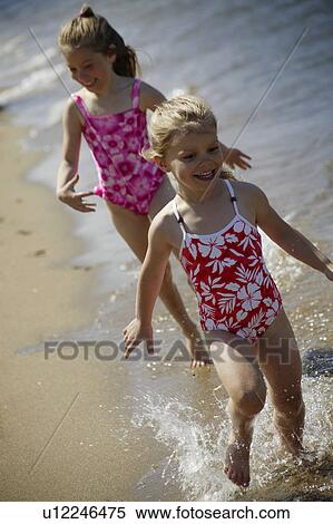 Stock Photography - Two children running along the beach. Fotosearch