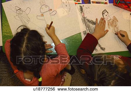 Two girls drawing Halloween pictures in their kindergarten class View Large Photo Image Stock Photograph - Two girls drawing Halloween pictures in their kindergarten class. Fotosearch
