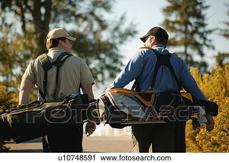 Two men carry golf bags View Large Photo Image Stock Image - Two men carry golf bags. Fotosearch