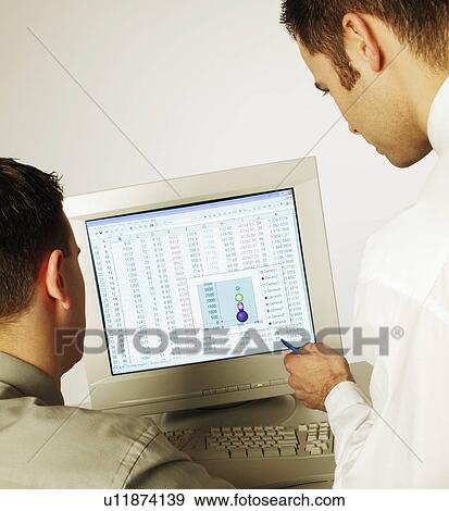 Stock Photo - Two men working on computer. Fotosearch