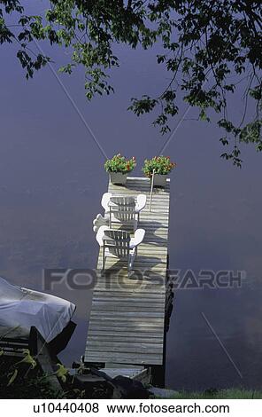 Stock Photo - Two outdoor chairs on the deck. Fotosearch