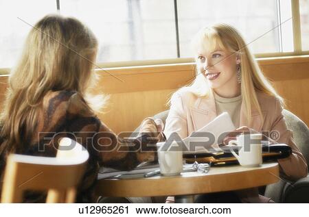 Two women having coffee View Large Photo Image Stock Image - Two women having coffee. Fotosearch