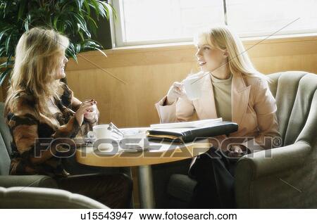 Two women having coffee View Large Photo Image Stock Photo - Two women having coffee. Fotosearch