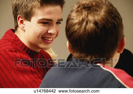 Two young guys have a discussion View Large Photo Image Stock Image - Two young guys have a discussion. Fotosearch