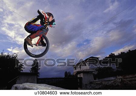 Unicyclist taking a jump View Large Photo Image Stock Image - Unicyclist taking a jump. Fotosearch