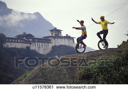 Unicyclists riding down hill View Large Photo Image Stock Image - Unicyclists riding down hill. Fotosearch