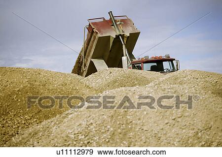 Stock Photo - Unloading at the gravel pile. Fotosearch