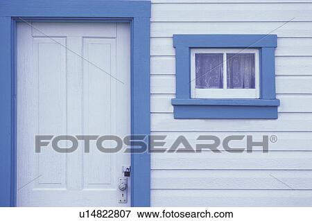 Stock Photo - White door and window on white siding with blue trim. Fotosearch