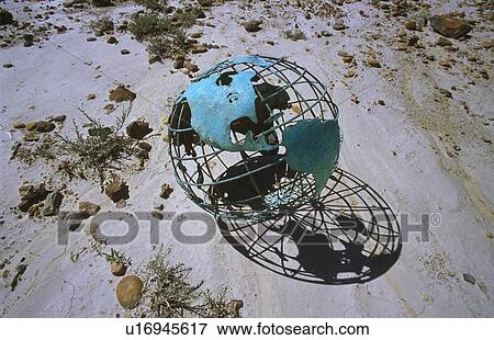 Stock Photo - Wire globe outside on sand. Fotosearch