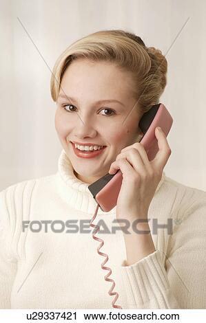 Stock Image - Woman answers the phone. Fotosearch