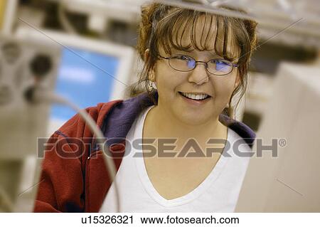 Woman at a computer View Large Photo Image Stock Image - Woman at a computer. Fotosearch