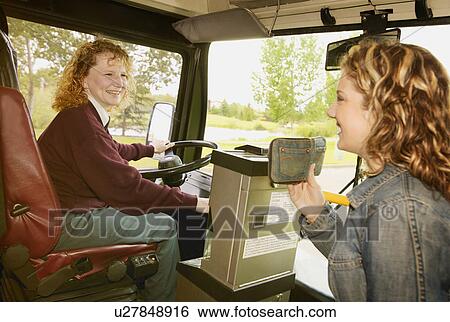 Woman boards a public bus View Large Photo Image Stock Photograph - Woman boards a public bus. Fotosearch