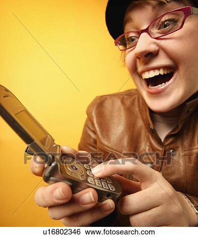 Woman dials cell phone View Large Photo Image Stock Photograph - Woman dials cell phone. Fotosearch