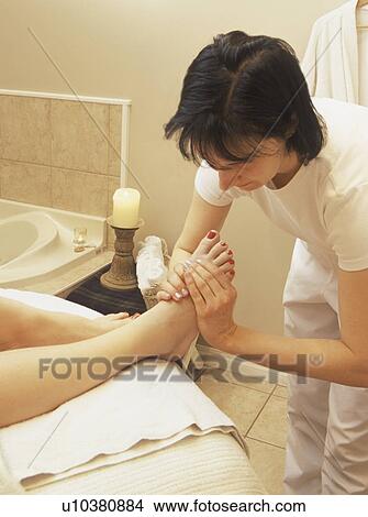 Picture - Woman getting foot massage. Fotosearch