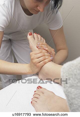 Stock Image - Woman getting foot massage. Fotosearch
