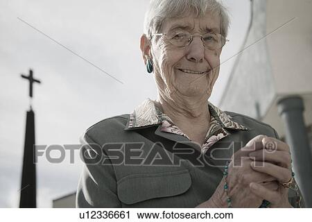 Woman holding rosary beads View Large Photo Image Stock Image - Woman holding rosary beads. Fotosearch