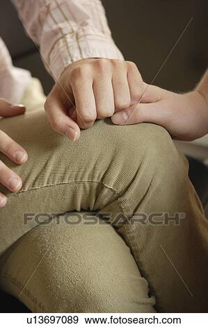 Woman holding the hand of another person on her lap View Large Photo Image Stock Photo - Woman holding the hand of another person on her lap. Fotosearch