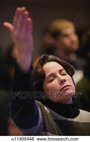 Stock Photo - Woman raising hand in worship. Fotosearch