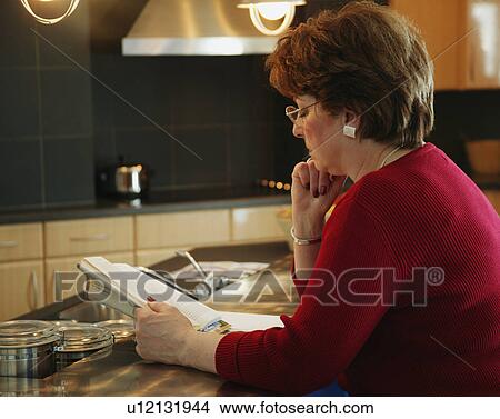 Picture - Woman reading a book. Fotosearch
