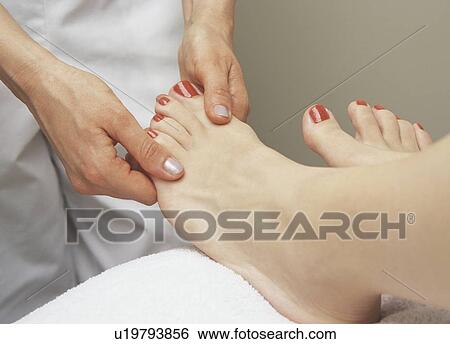 Stock Photograph - Woman receiving a foot massage. Fotosearch