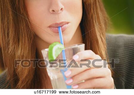 Stock Photo - Woman sipping cold drink. Fotosearch