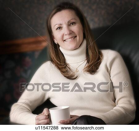 Stock Photo - Woman smiles with cup of coffee. Fotosearch