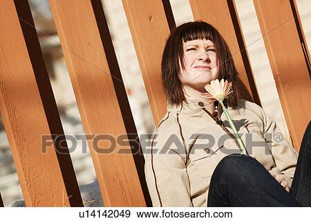 Woman squints at sunlight View Large Photo Image Stock Photo - Woman squints at sunlight. Fotosearch