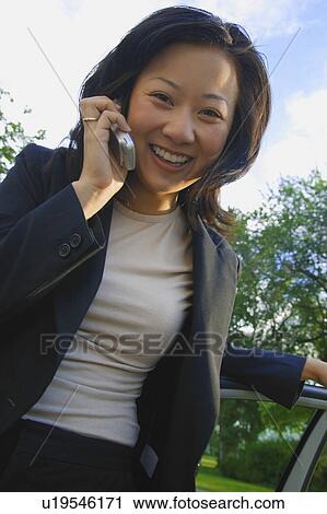Woman talks on cell phone View Large Photo Image Stock Image - Woman talks on cell phone. Fotosearch