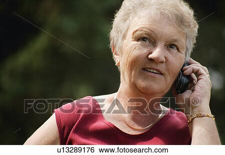 Woman talks on the phone View Large Photo Image Stock Photograph - Woman talks on the phone. Fotosearch