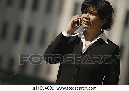 Woman using cell phone View Large Photo Image Stock Photography - Woman using cell phone. Fotosearch