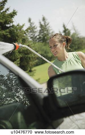 Stock Image - Woman washing the car. Fotosearch