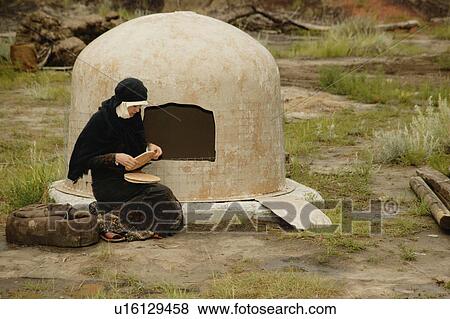Woman wearing black bakes bread View Large Photo Image Stock Photo - Woman wearing black bakes bread. Fotosearch