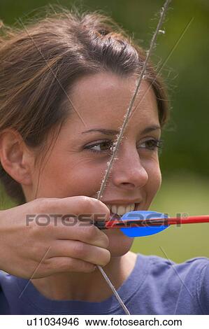 Stock Photograph - Woman with bow and arrow. Fotosearch