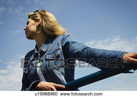 Stock Image - Woman with jean jacket. Fotosearch