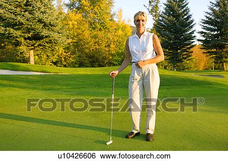 Woman with putter View Large Photo Image Stock Photograph - Woman with putter. Fotosearch