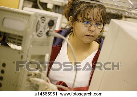 Stock Image - Woman working on a computer. Fotosearch