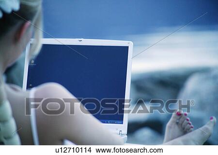 Woman works on lap top computer at the beach View Large Photo Image Picture - Woman works on lap top computer at the beach. Fotosearch