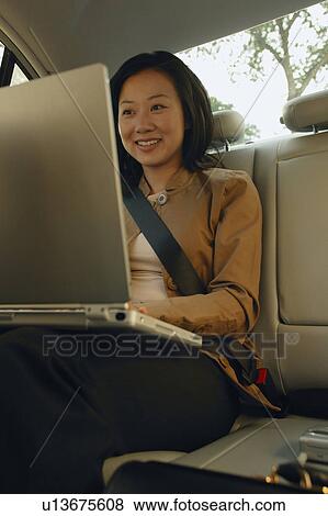 Stock Photo - Woman works on lap top. Fotosearch
