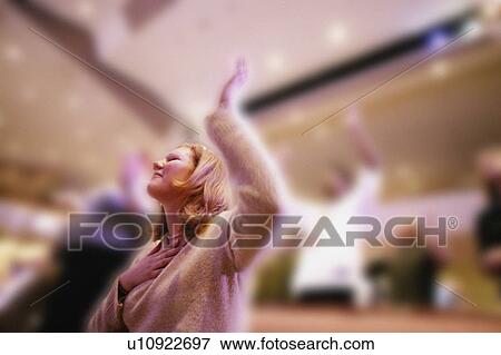Woman worshipping in church View Large Photo Image Stock Photo - Woman worshipping in church. Fotosearch