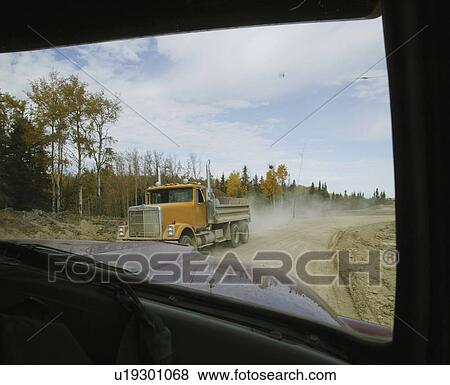 Stock Photo - Work trucks passing each other. Fotosearch