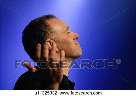 Stock Image - Worship leader raising hands. Fotosearch