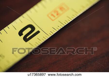 Stock Photo - Yellow and black tape measure. Fotosearch