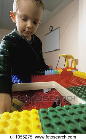 Young boy playing with large Lego blocks View Large Photo Image Stock Photography - Young boy playing with large Lego blocks. Fotosearch