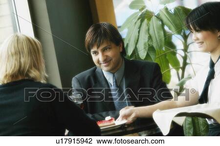 Young couple at table View Large Photo Image Stock Image - Young couple at table. Fotosearch