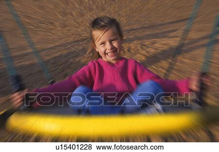 Young girl on playground ride View Large Photo Image Stock Photo - Young girl on playground ride. Fotosearch