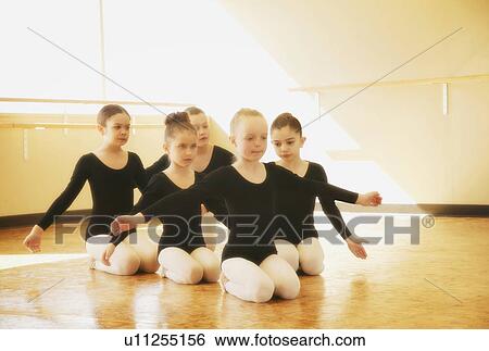 Stock Photograph - Young girls practice dance routine. Fotosearch