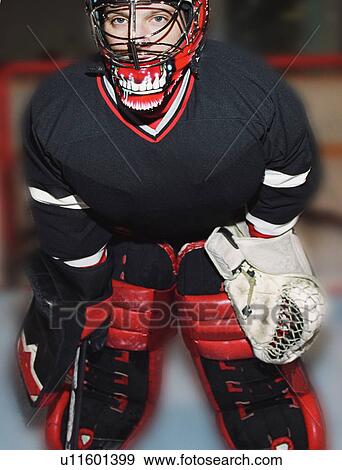 Young hockey goalie in net View Large Photo Image Stock Photo - Young hockey goalie in net. Fotosearch