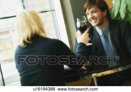 Stock Photo - Young professional couple drinking wine. Fotosearch