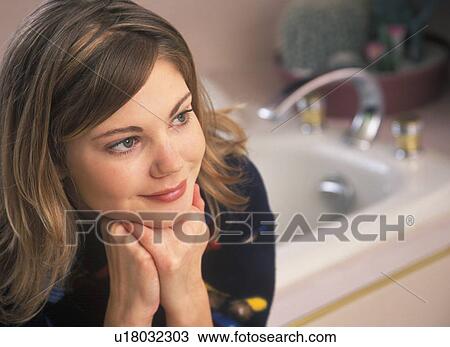 Young woman with chin on hands View Large Photo Image Stock Image - Young woman with chin on hands. Fotosearch